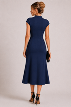 Navy blue polyester fitted midi dress with high neckline and short sleeves worn by a female fashion model.