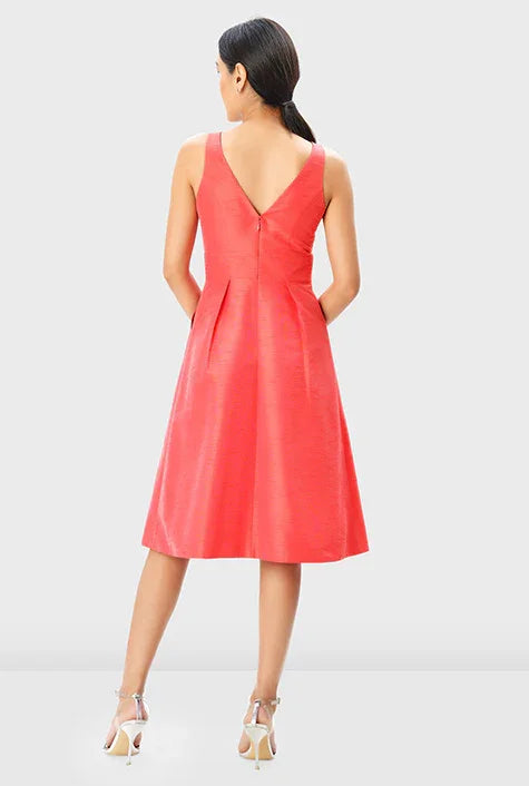 Sleeveless V-neck Banded Empire Dupioni A-line dress by Nams Ropa, perfect for wedding guests, midi length, elegant style.