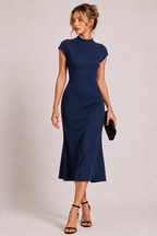 Navy blue polyester fitted midi dress with high neckline and short sleeves worn by a female fashion model.