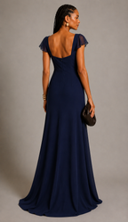 Navy blue polyester crepe maxi dress with sweetheart neckline, flutter sleeves, fitted bodice, and flowing floor-length A-line skirt worn by a female fashion model.
