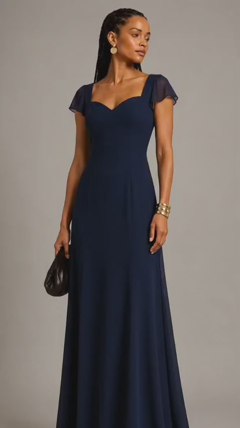 Navy blue polyester crepe maxi dress with sweetheart neckline, flutter sleeves, fitted bodice, and flowing floor-length A-line skirt worn by a female fashion model.
