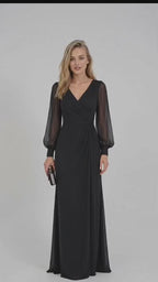 Black French crepe maxi dress featuring a V-neckline, wrap-style ruched bodice, sheer long puff sleeves with fitted cuffs, gathered waist, and flowing floor-length skirt.
